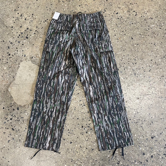 rear view of black, white and green abstract print camo pants