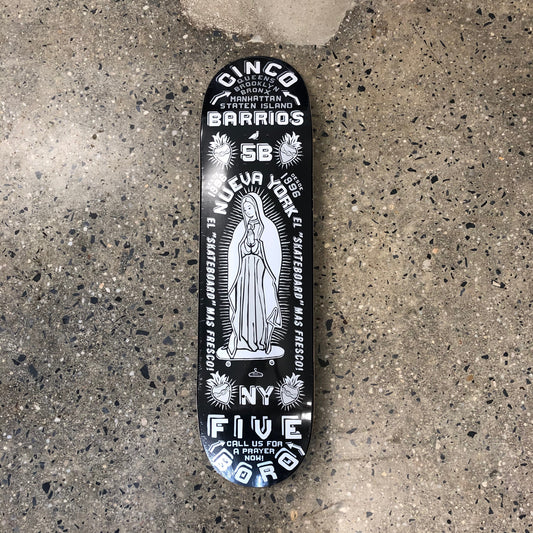 black skateboard with silver text and religious figure in the middle