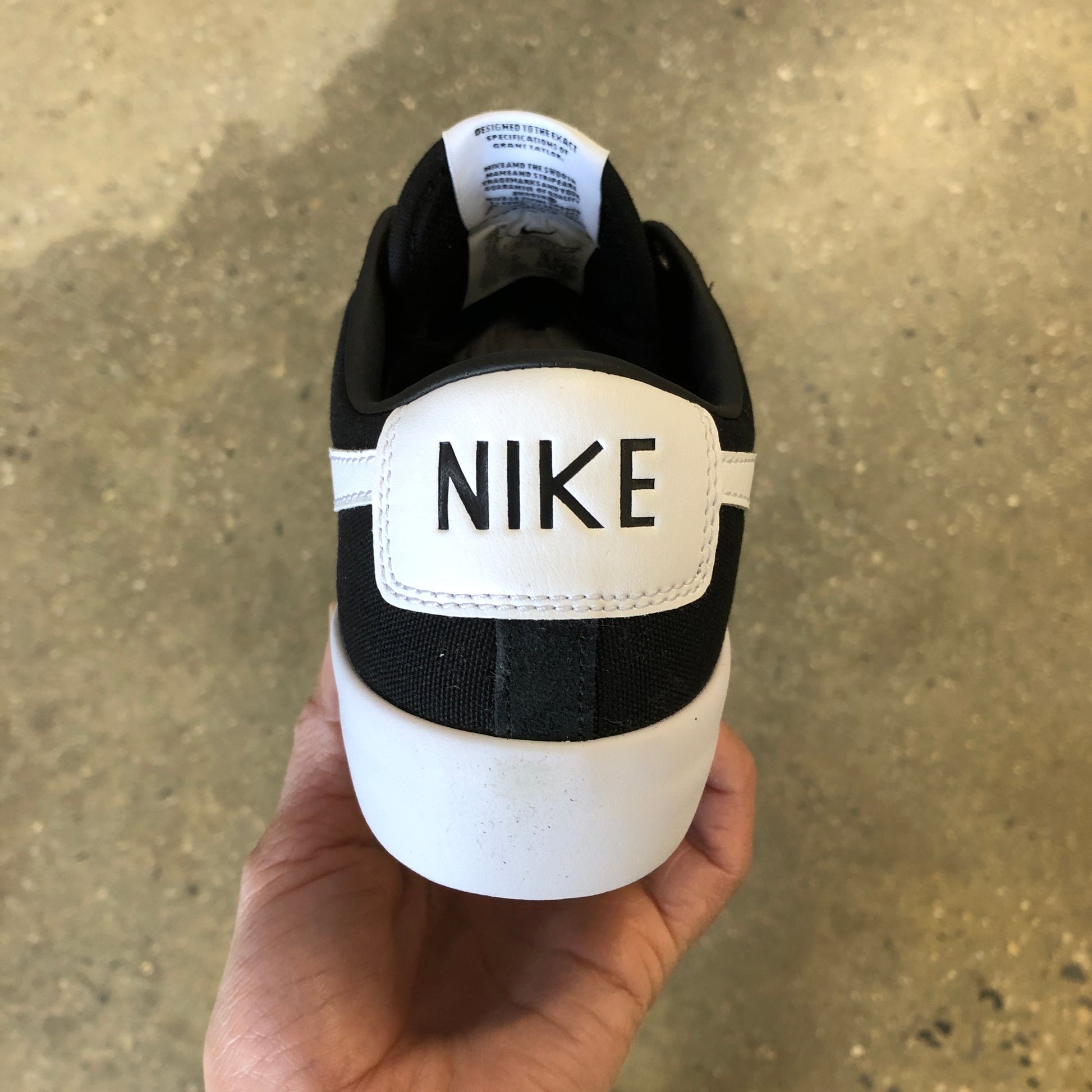 rear view of black suede sneaker with white sole