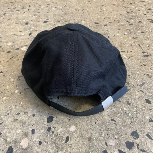 rear view of black six panel cap with black leather strap