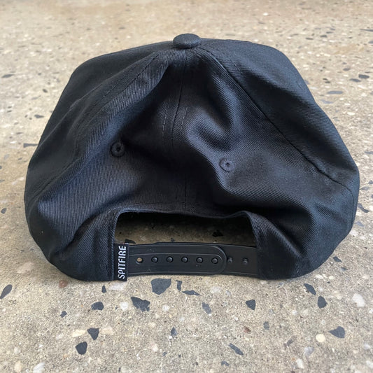 back view of black hat, snap closure 