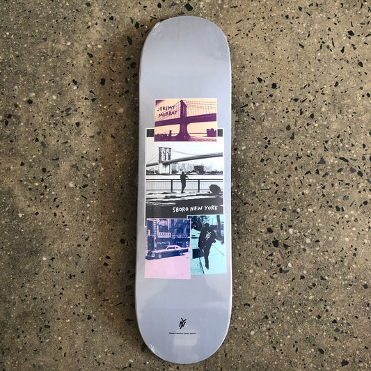 silver skateboard with a photo collage in the middle and small black text