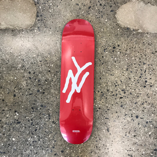 red skateboard with a white NY graphic 
