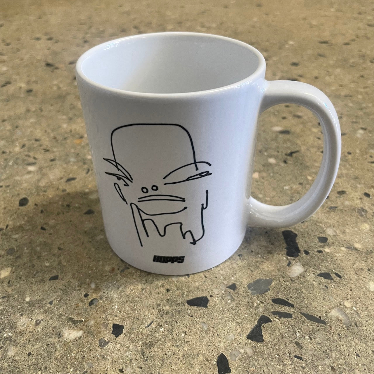 hand drawn face logo on white mug