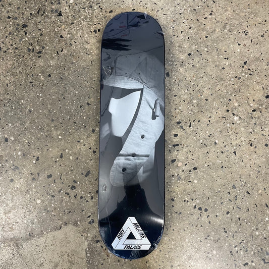 white mannequin head with hat on black skate deck
