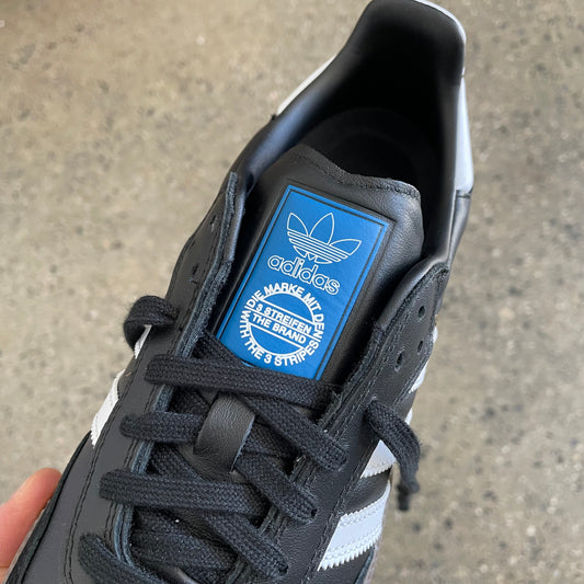 closeup of blue logo and black laces, top view