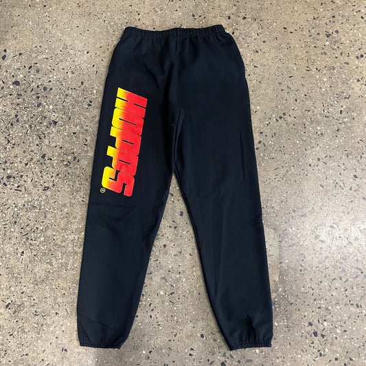 red and yellow fade graphic on black sweatpants