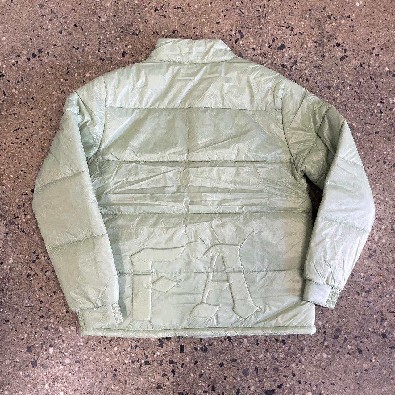 back view of jade puffer jacket, FA logo on bottom
