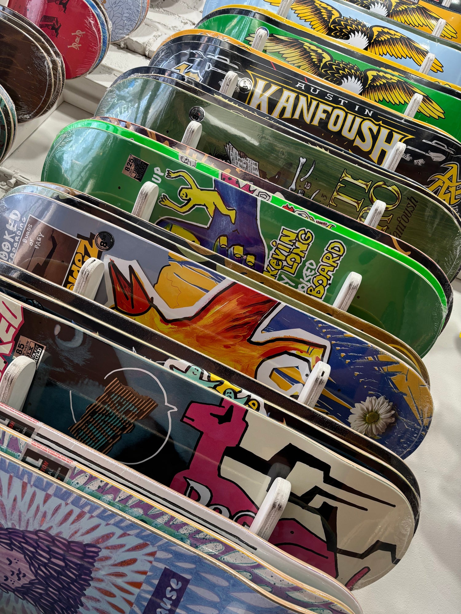 view of assorted DLX brand skateboard deck on the board wall