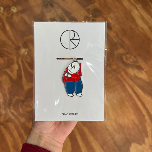 Keychain of a person with a red top and blue pants