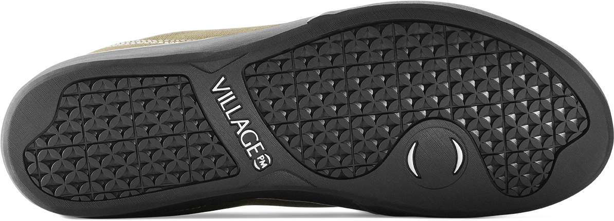 Close-up of the black textured outsole of a shoe, showing the brand name VILLAGE printed on the side.