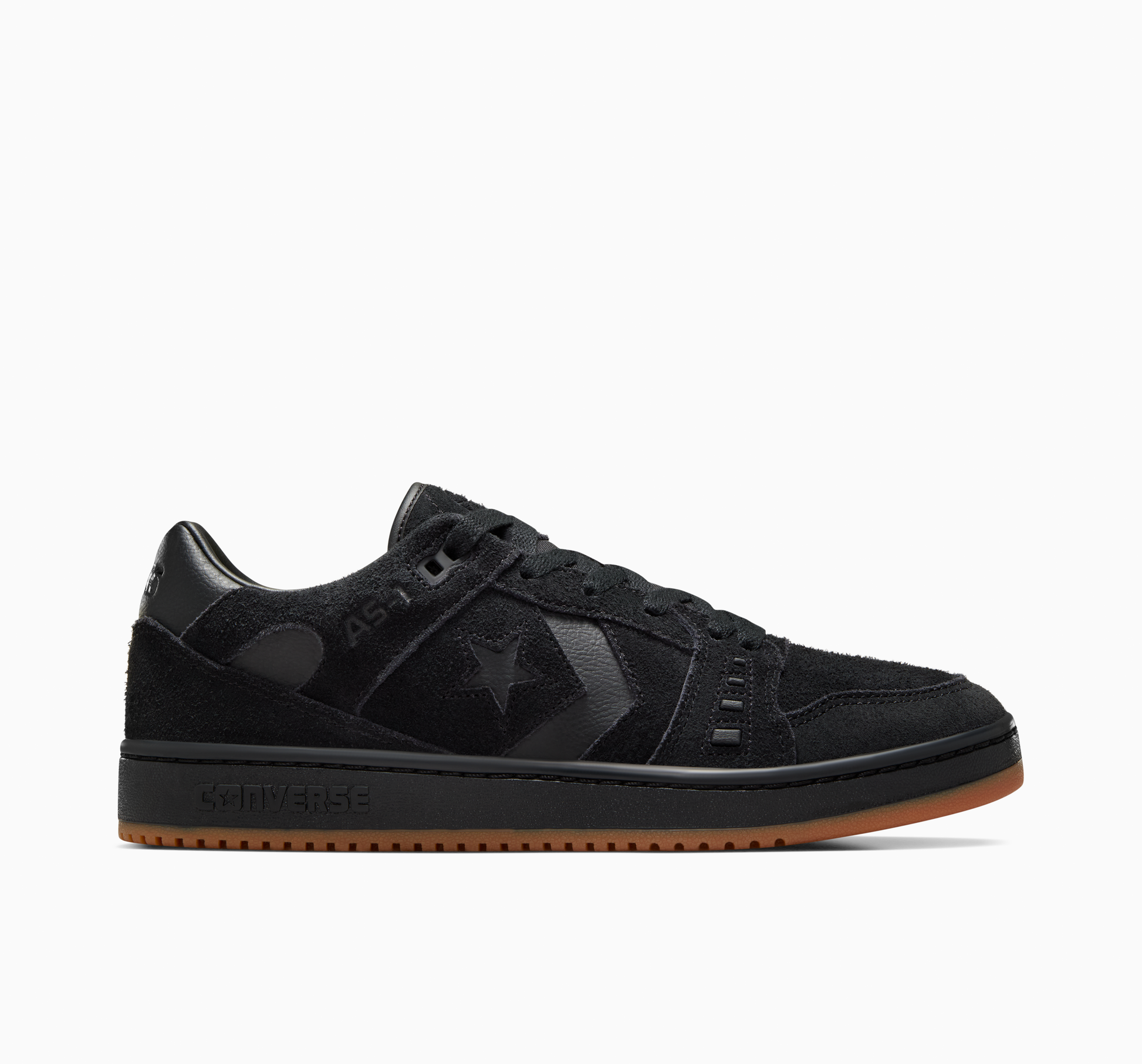 Side view of all black suede lowtop sneaker with gum sole on the bottom of shoe