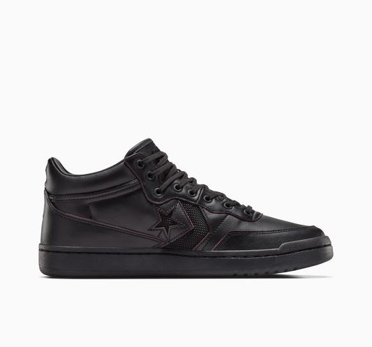 side view of black leather mid top skateboard shoe