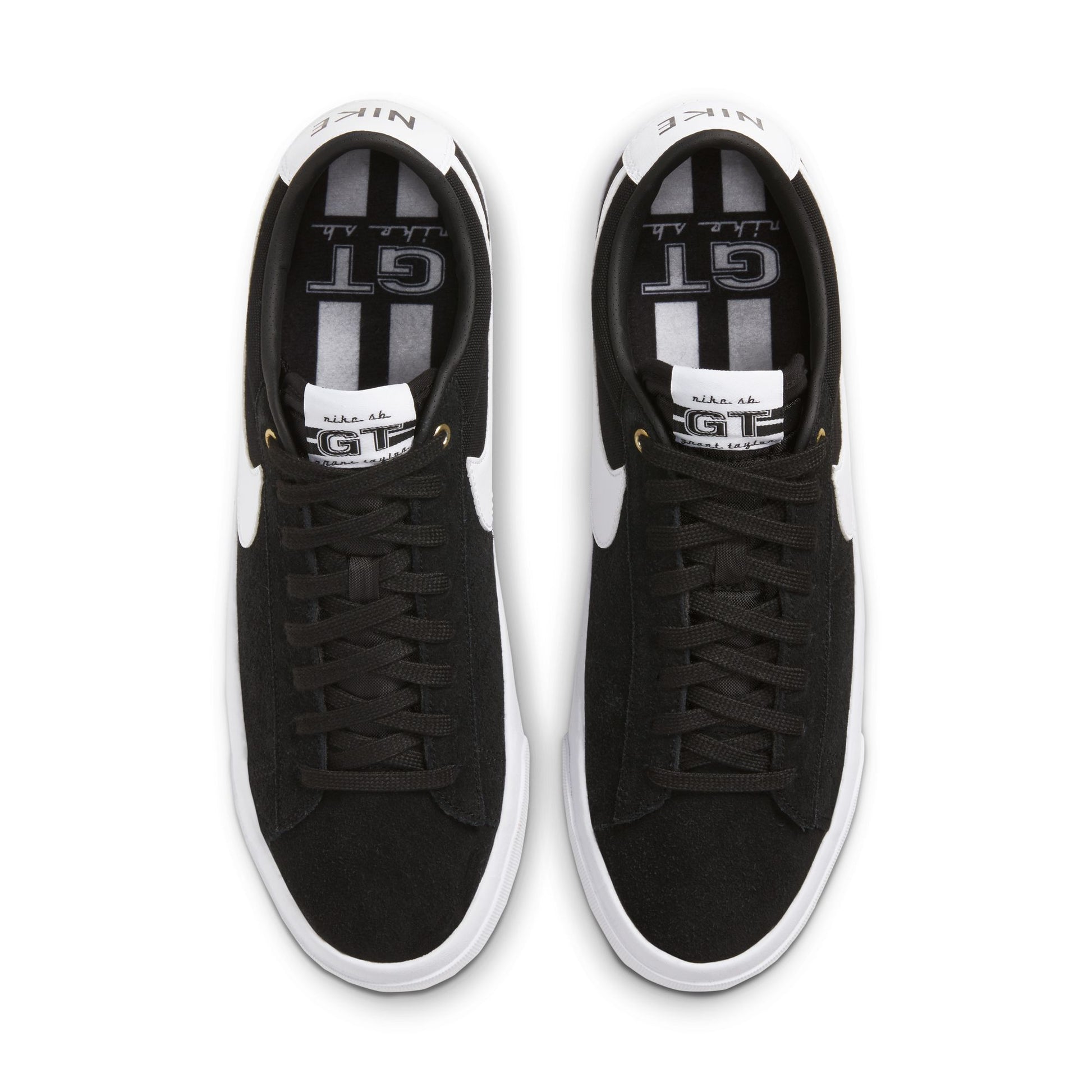 overhead view of Black sneakers with white soles on a white background