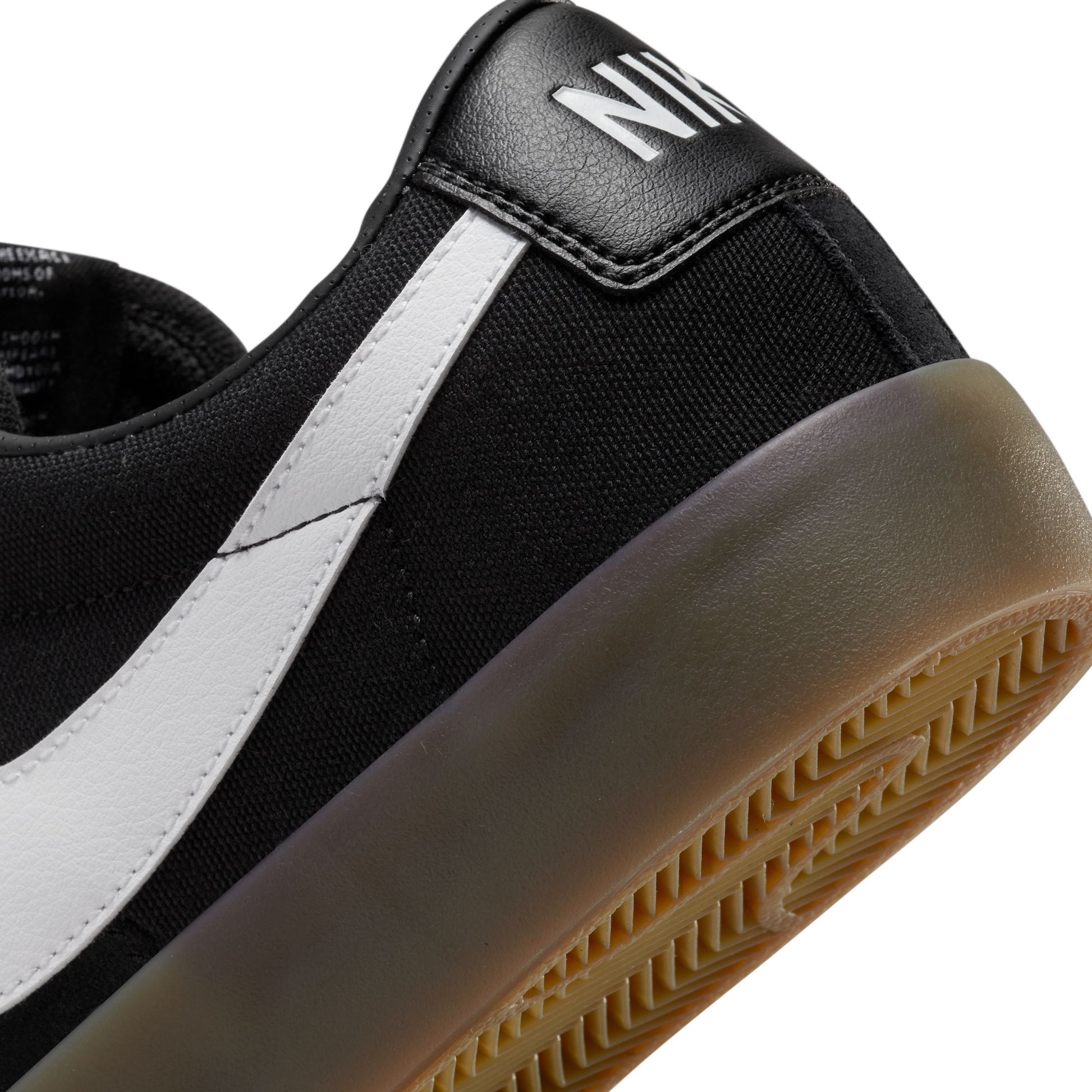 view of heel tab on black and gum sneaker
