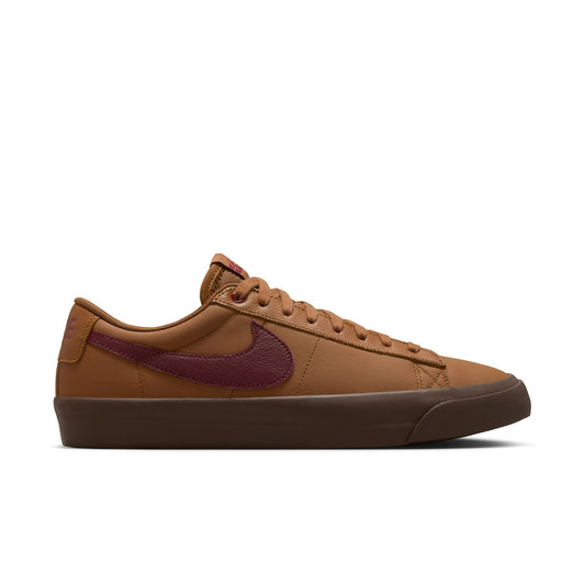 Brown sneaker with a maroon swoosh logo on a white background