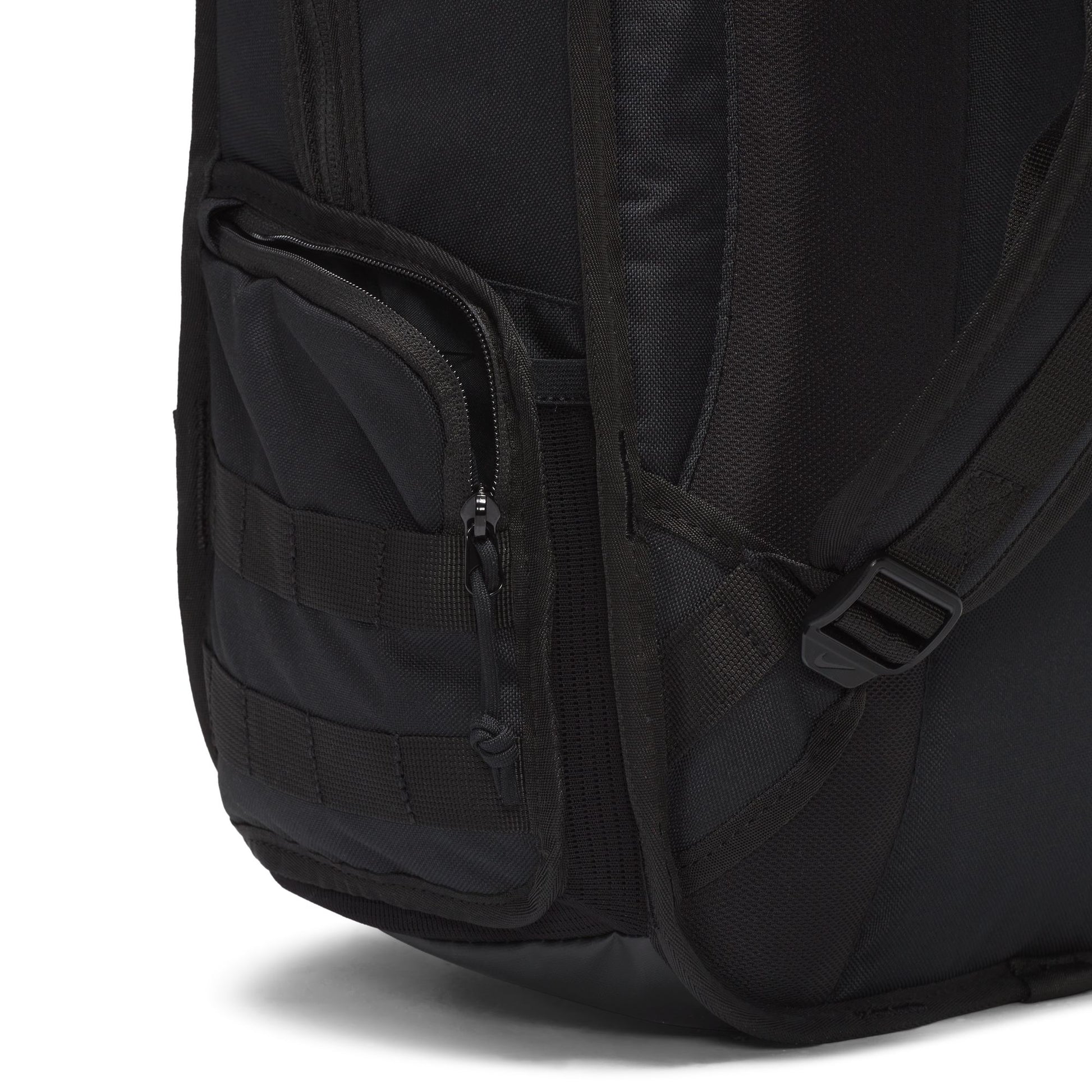Close-up of a black backpack with multiple pockets and straps on a white background