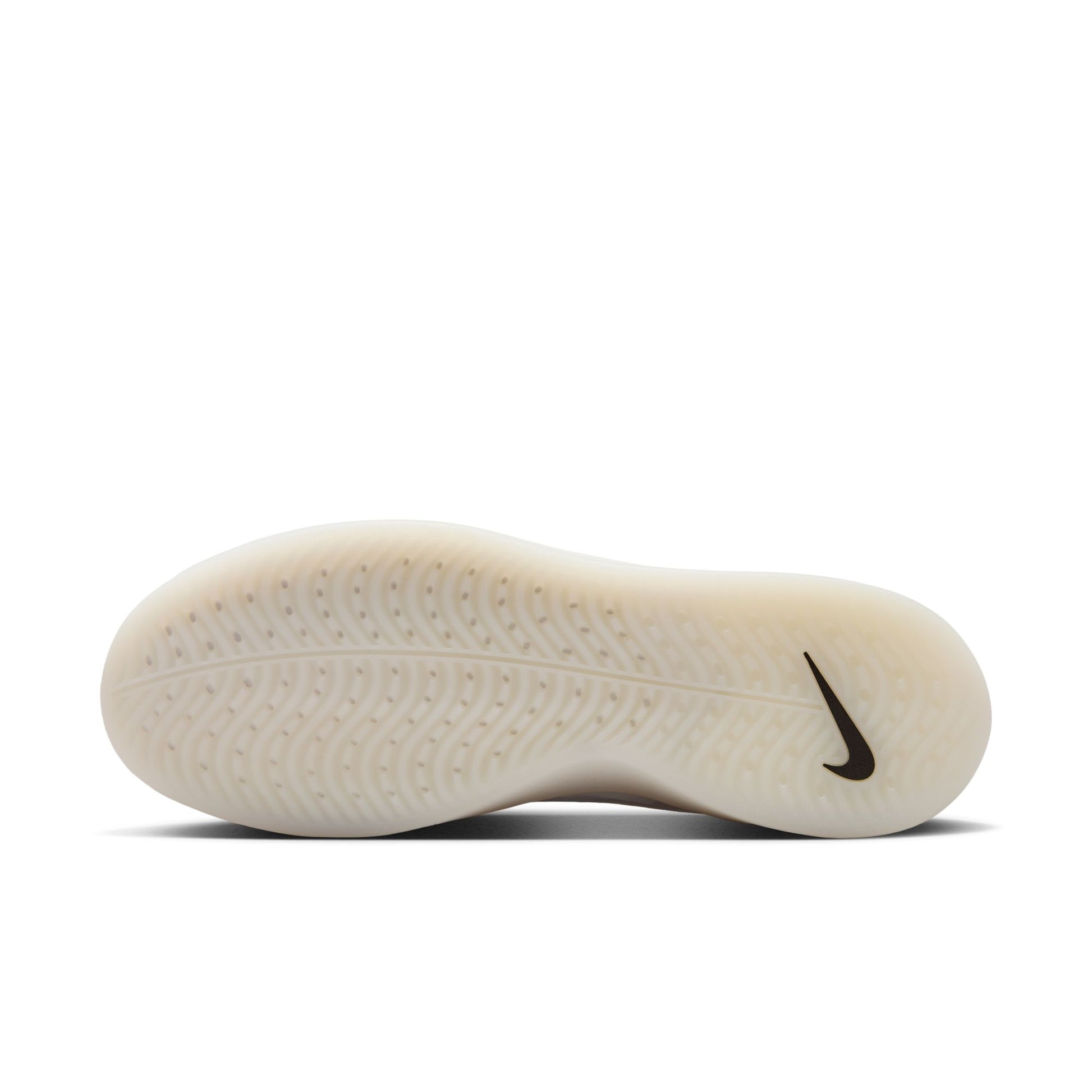 Close-up of a Nike shoe sole with tread pattern and logo on a white background