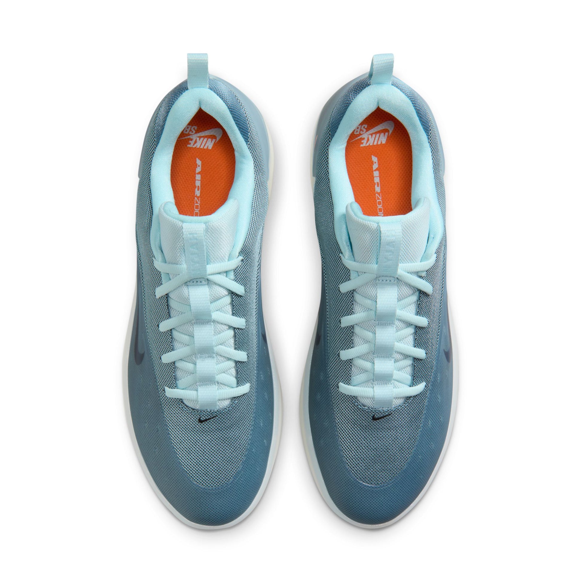 Pair of light blue athletic shoes with orange interior on a white background