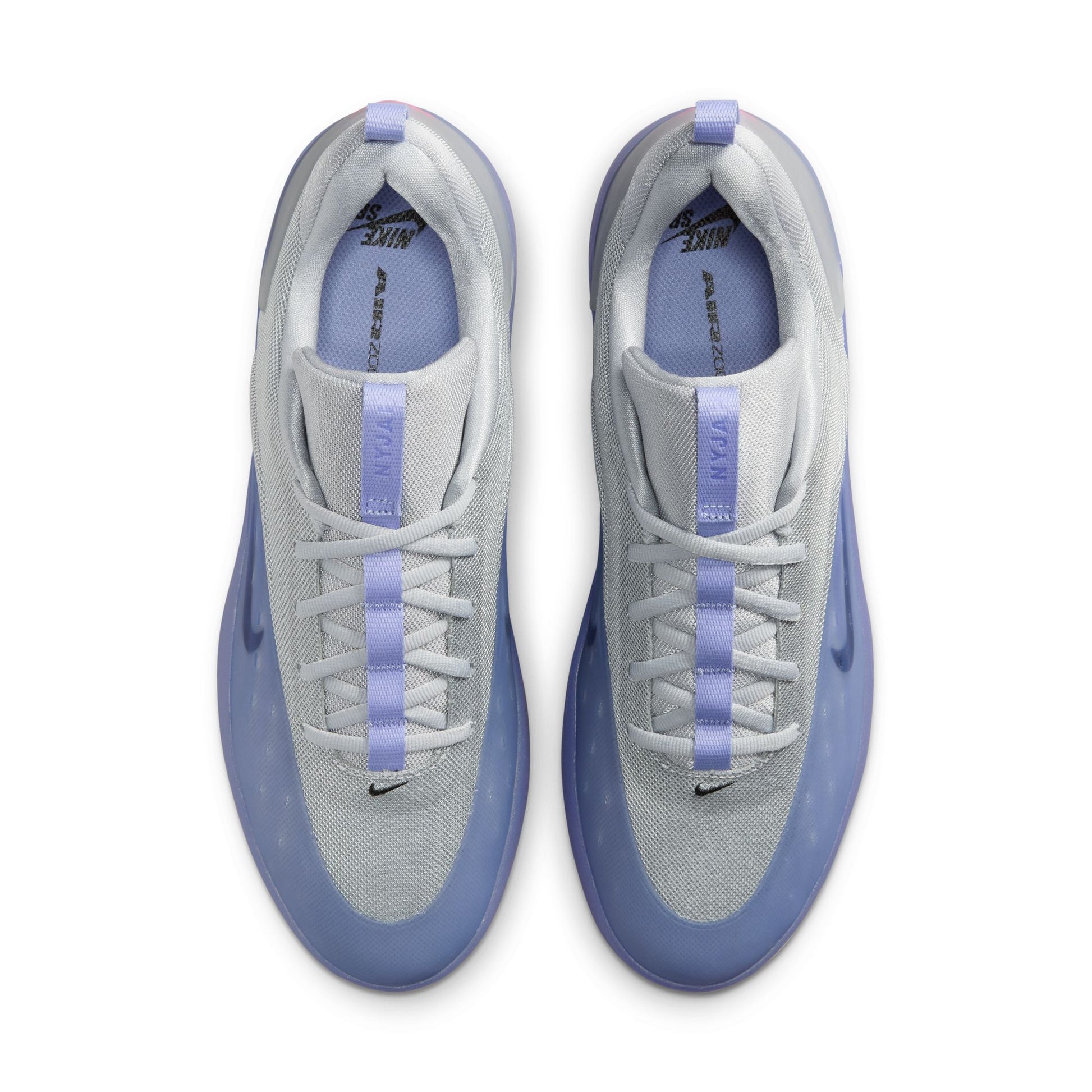 Gray sneakers with purple accents on a white background