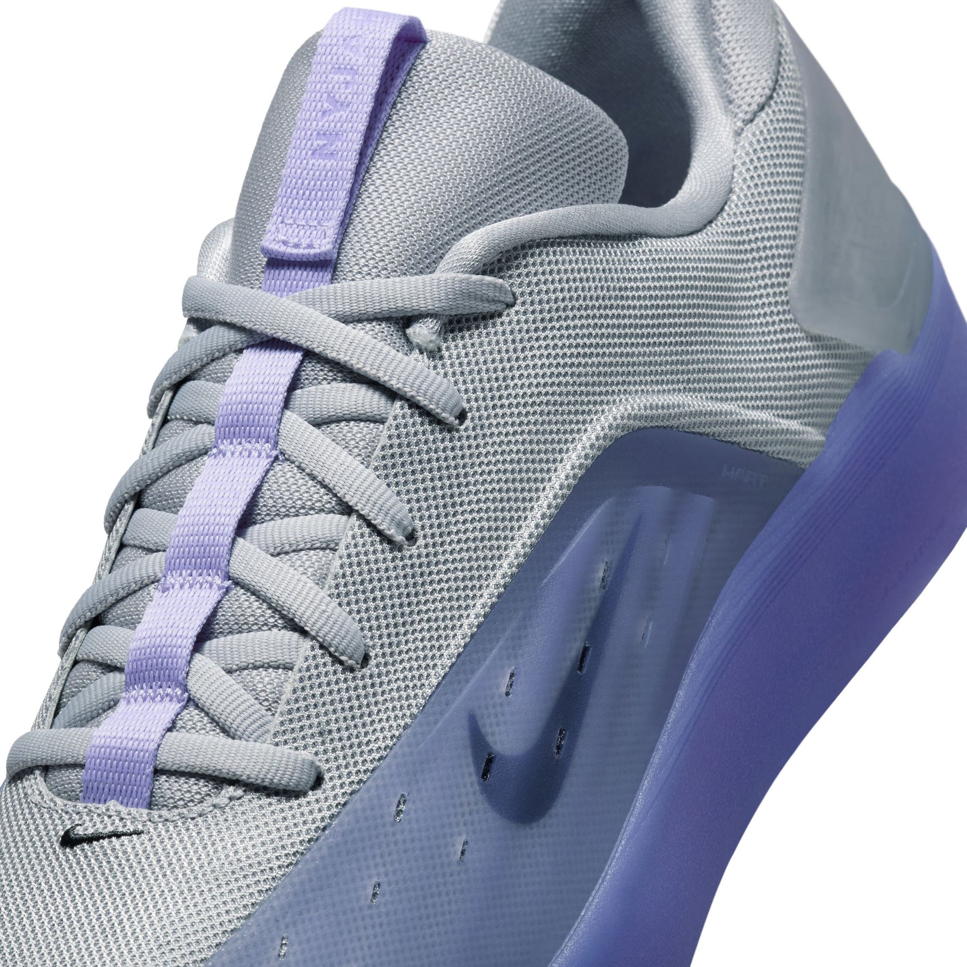 Gray and blue sneaker with purple accents on a white background