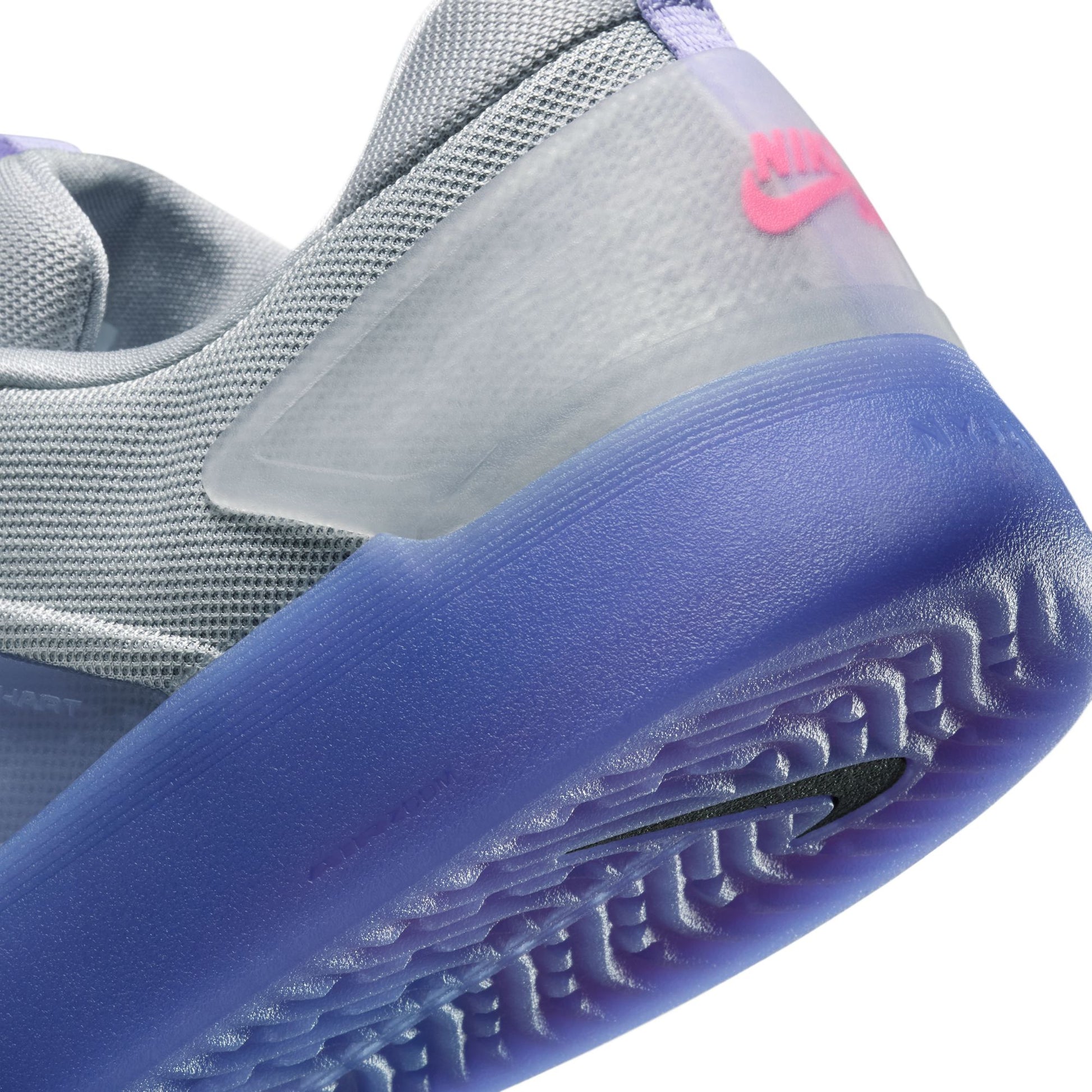 Close-up of a gray and blue sneaker with a Nike logo on a white background