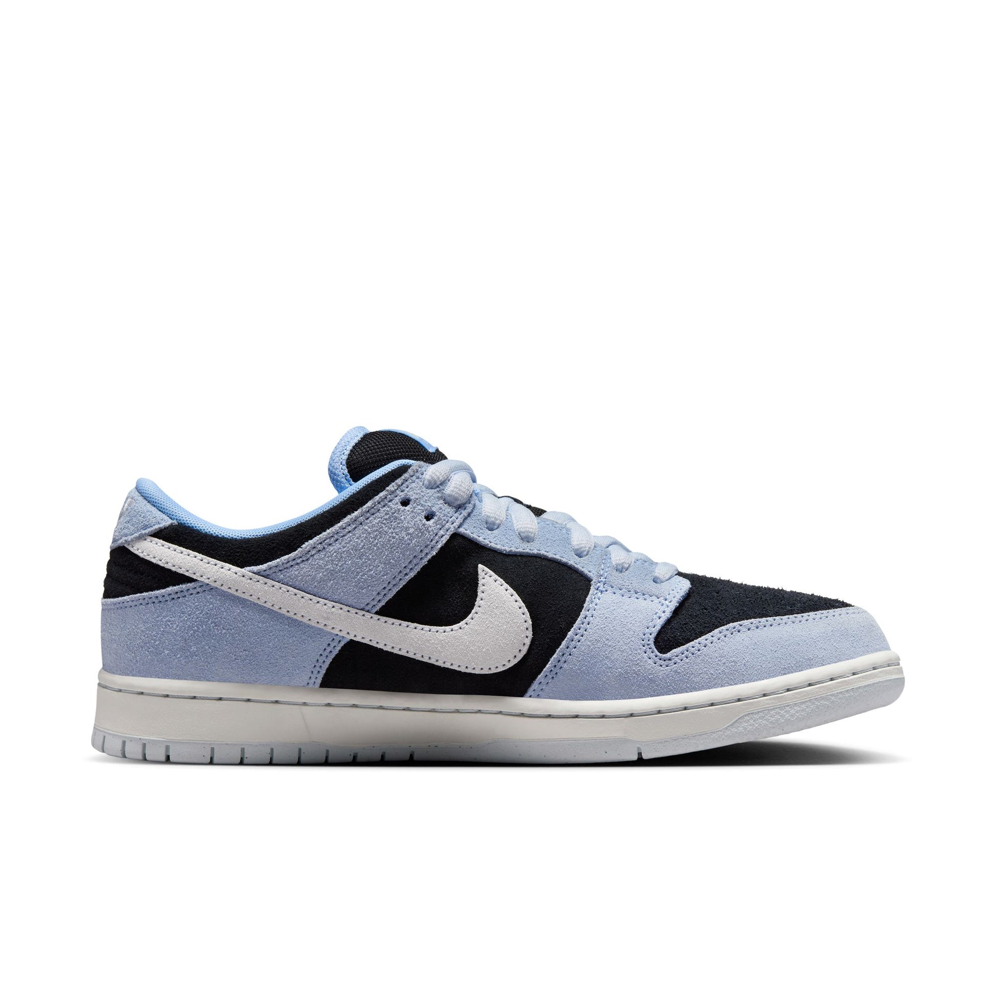 side view of light blue, white, and black suede low top Nike sb sneaker