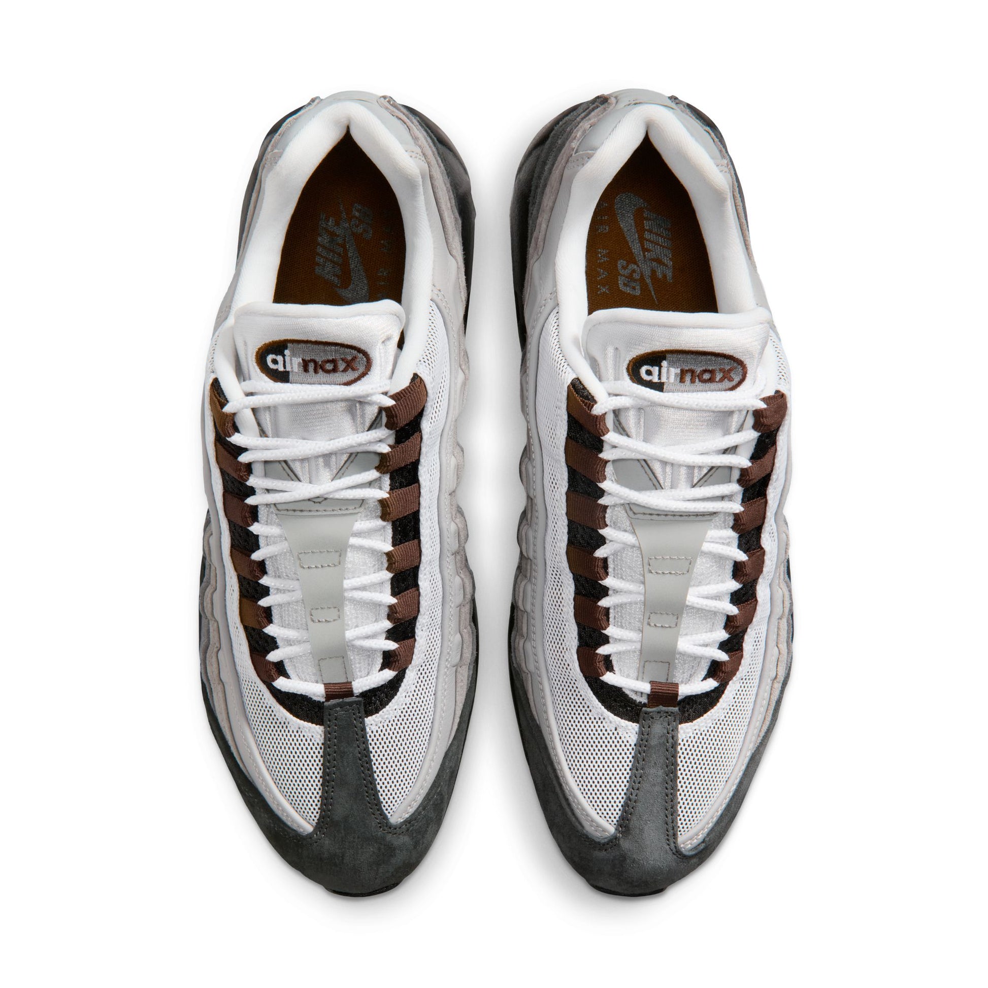 Pair of white and gray sneakers with brown accents on a white background
