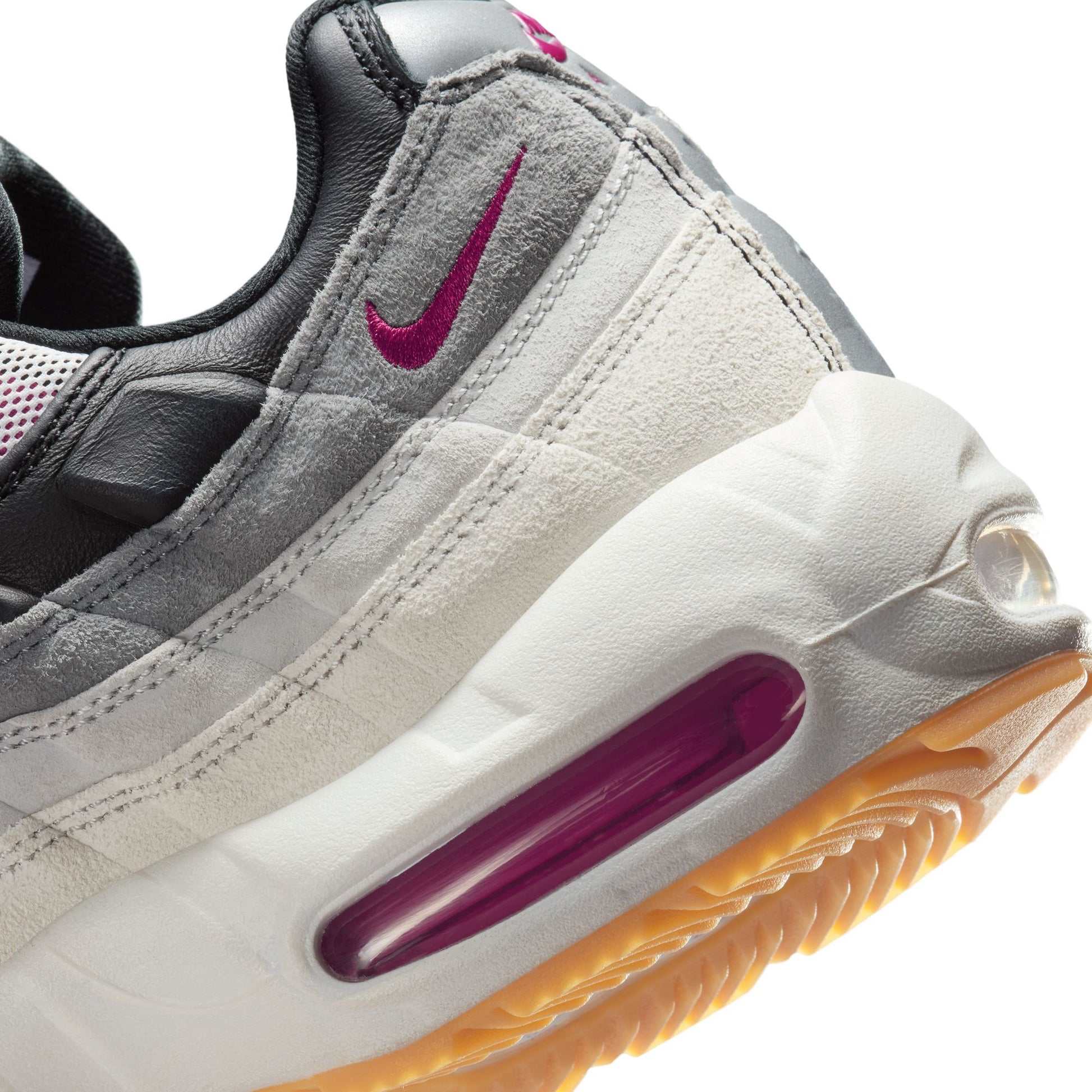 Gray sneaker with a purple swoosh logo and air bubble on a white background