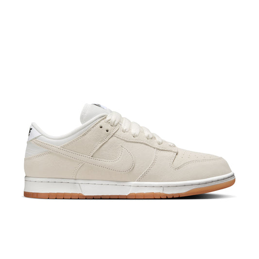 Side view of white suede lowtop sneaker