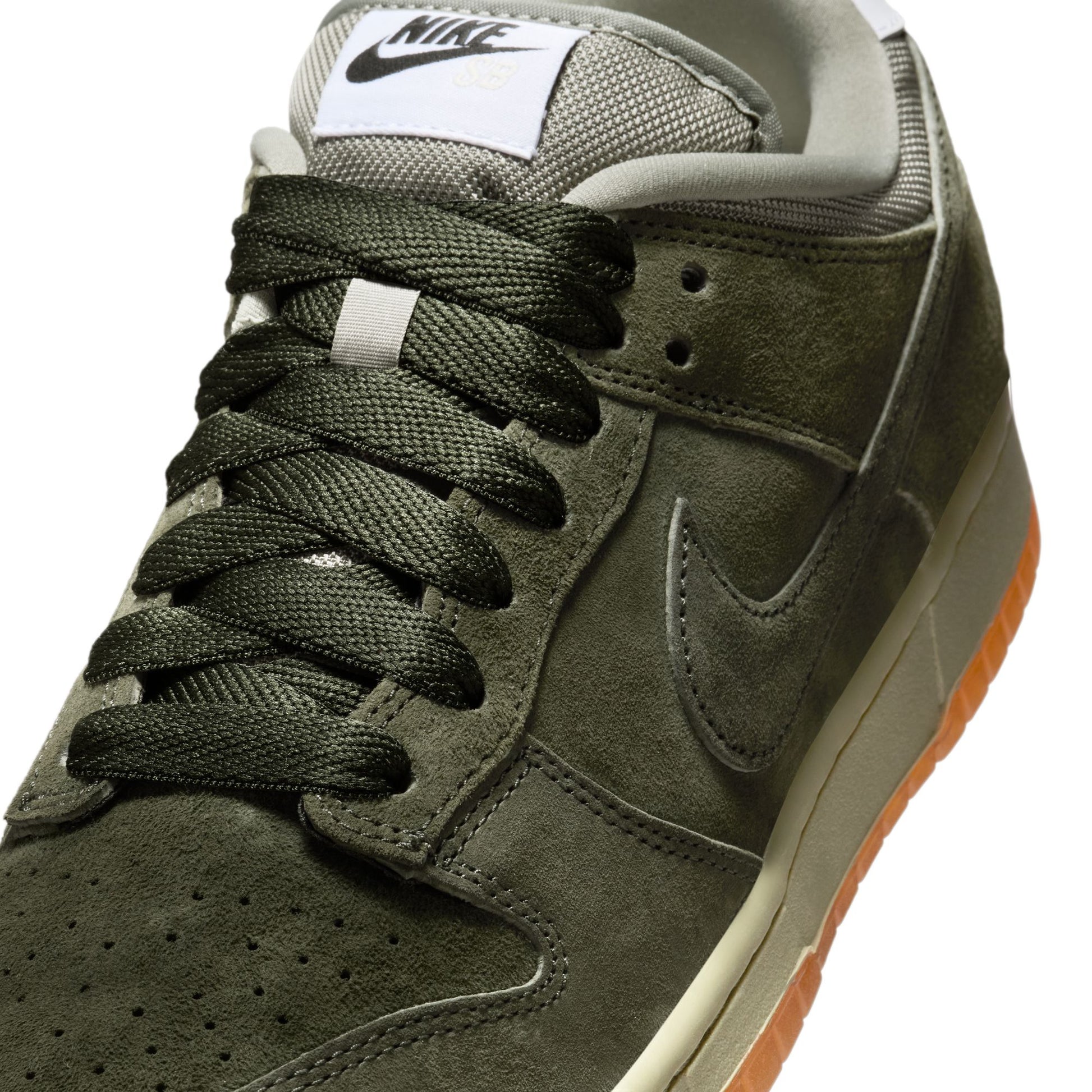 Green Nike sneaker with white label on a white background
