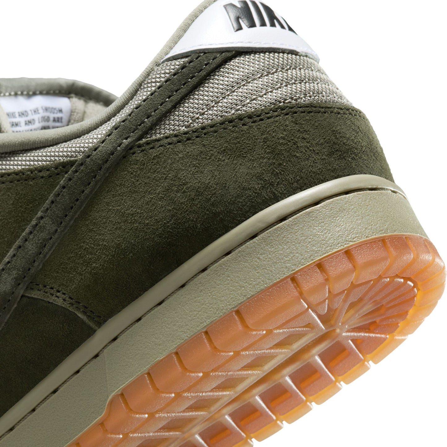 Close-up of a green sneaker with a white Nike logo on a white background