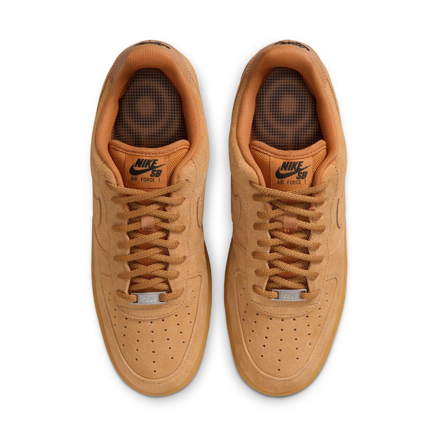 Pair of tan Nike SB sneakers on a white background