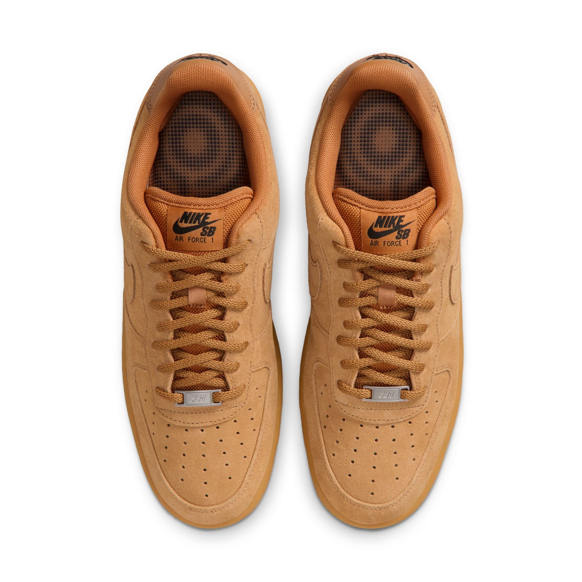 Pair of tan Nike SB sneakers on a white background