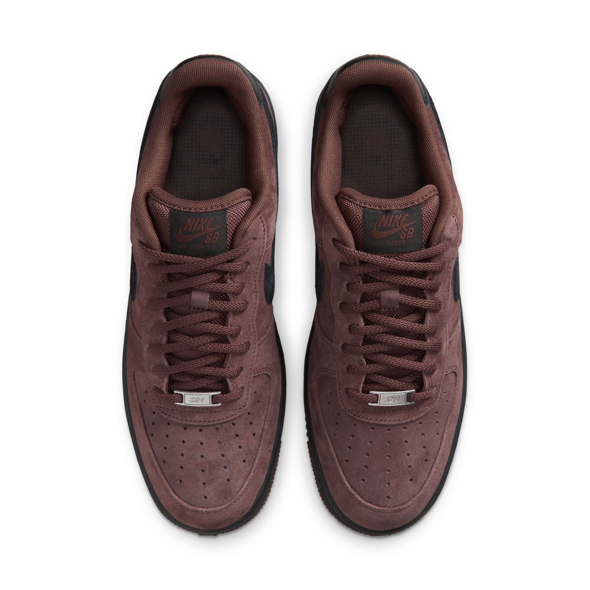 A pair of Nike Air Force 1 Low sneakers in a dark brown suede and leather mix, shown from a top-down view on a white background.