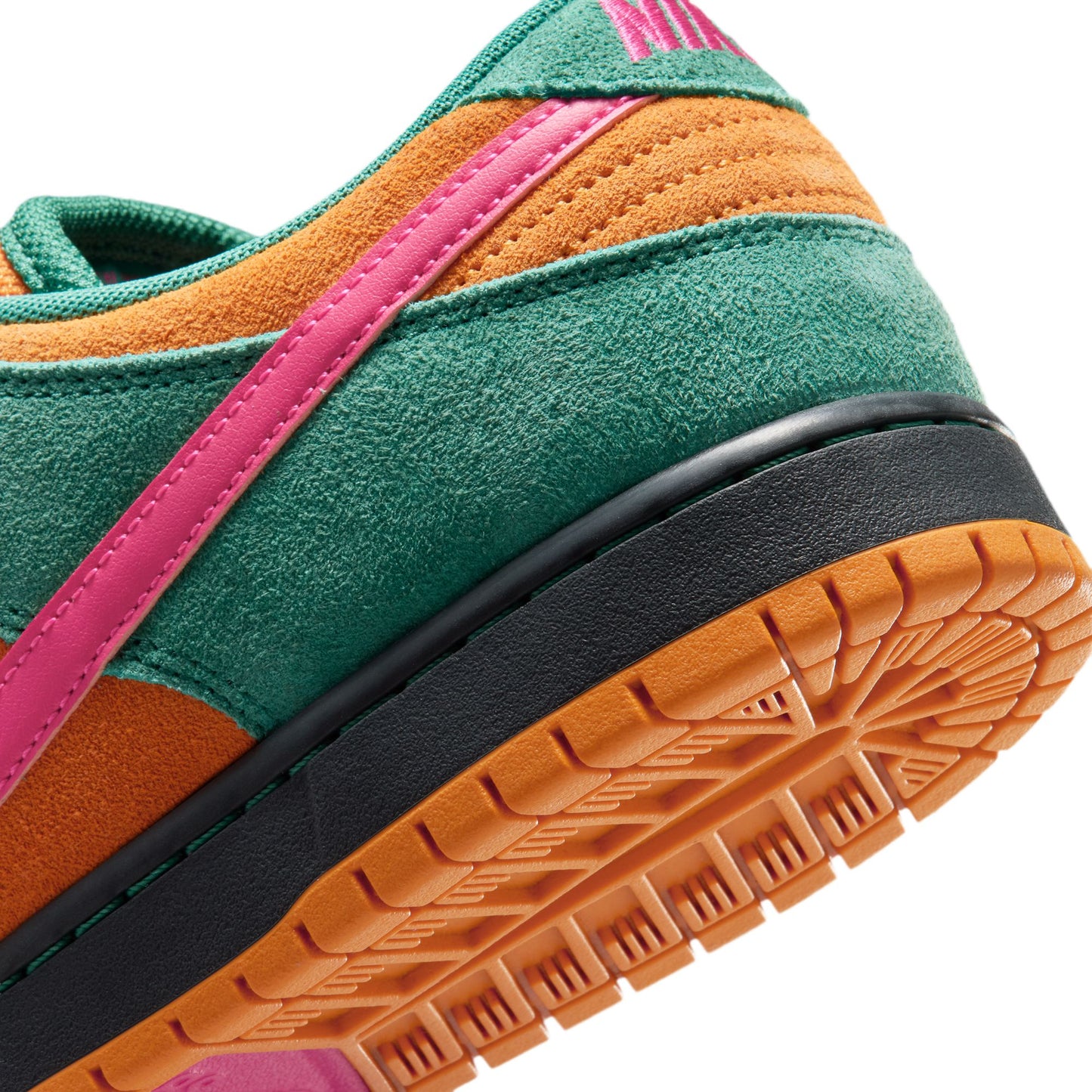 Close-up of a colorful sneaker with green, orange, and pink accents on a white background.
