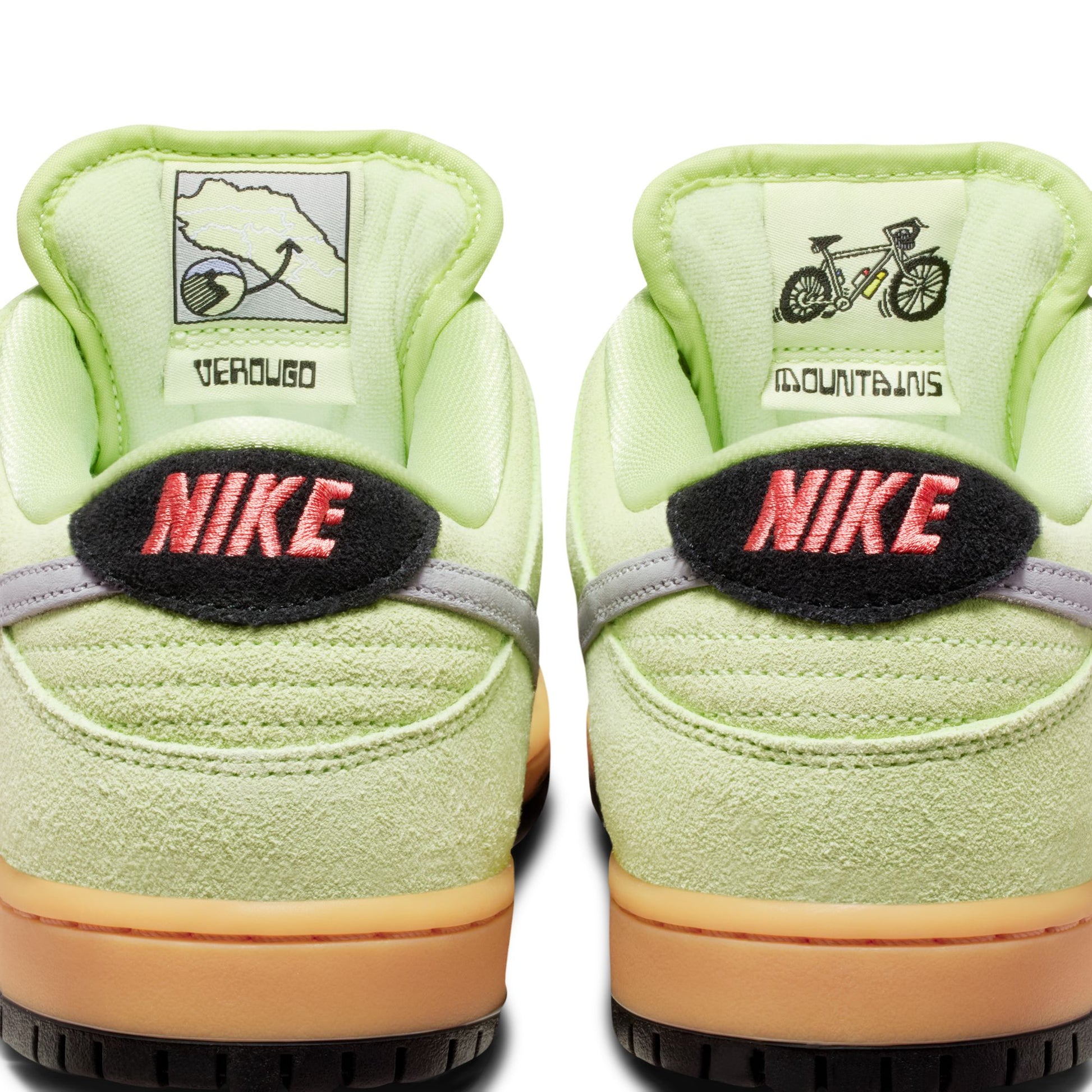 Light green Nike sneakers with brand logos on a white background