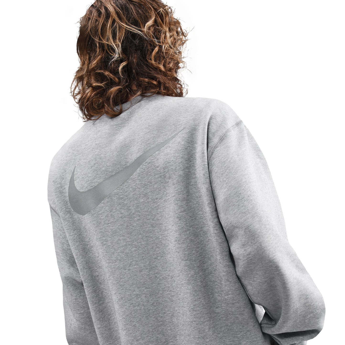 Person wearing a gray Nike sweatshirt on a white background