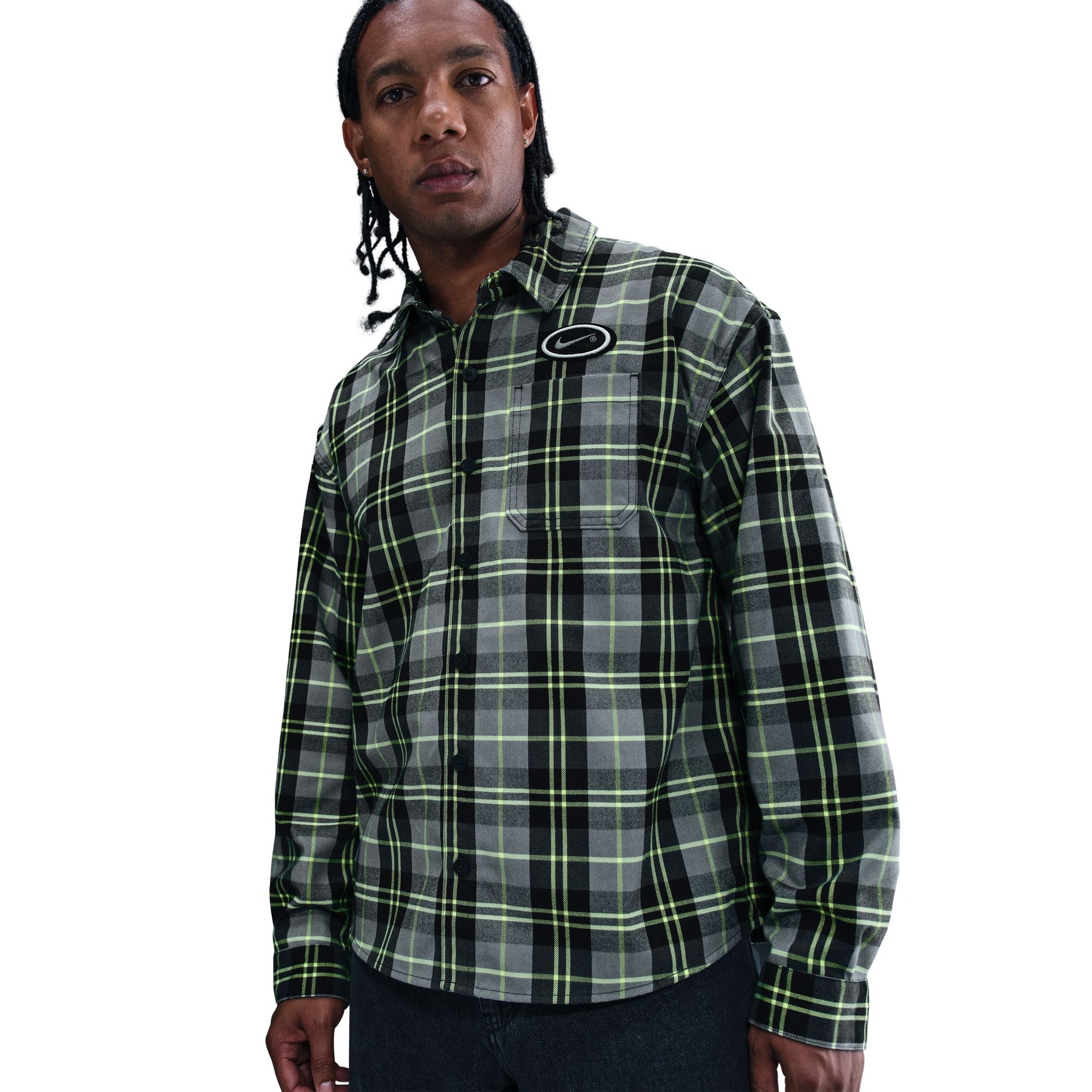 Person wearing a green and black plaid shirt on a white background