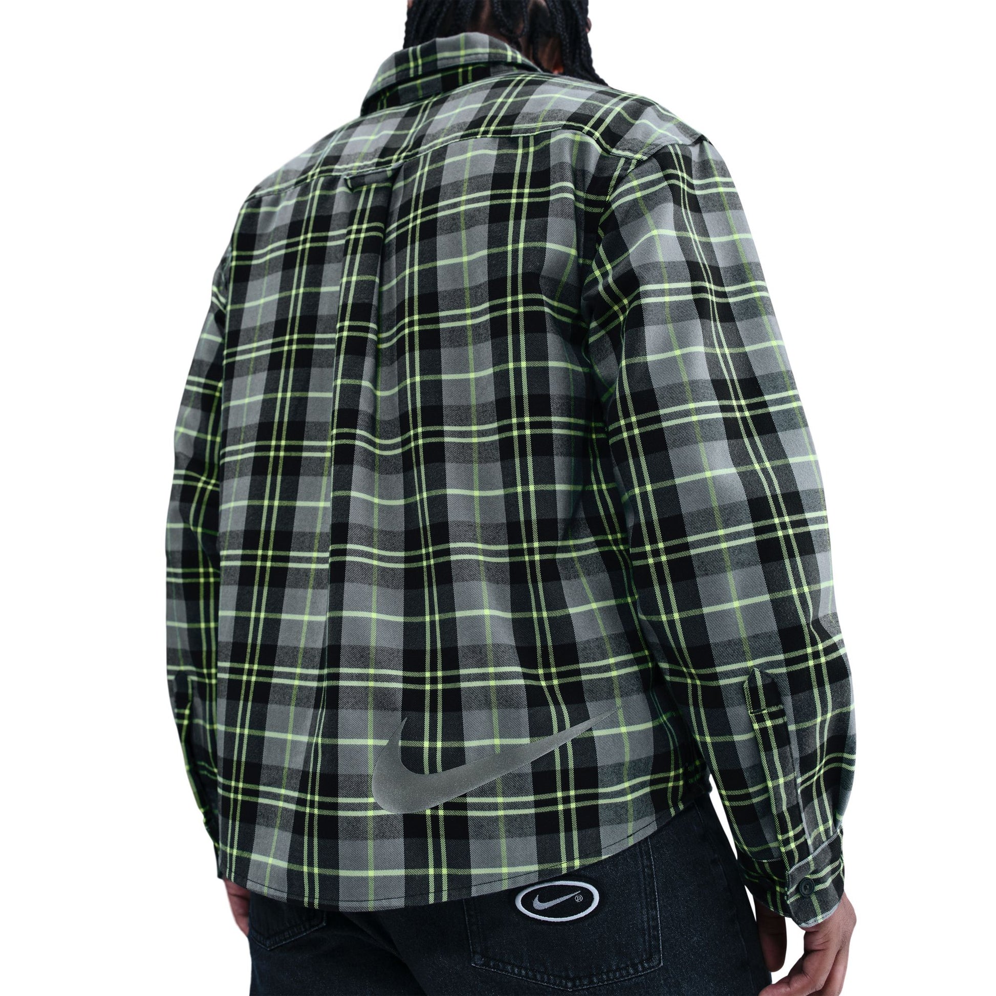 Green and black plaid shirt worn by a person on a white background