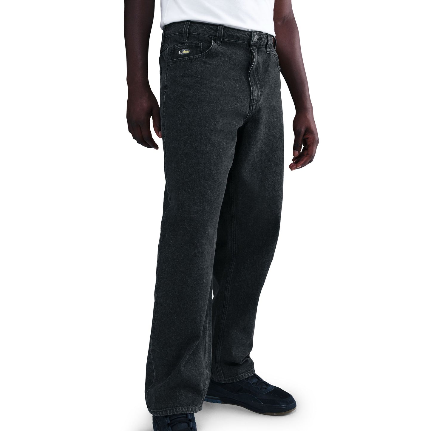 Person wearing dark gray jeans on a white background