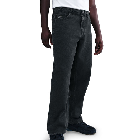 Person wearing dark gray jeans on a white background