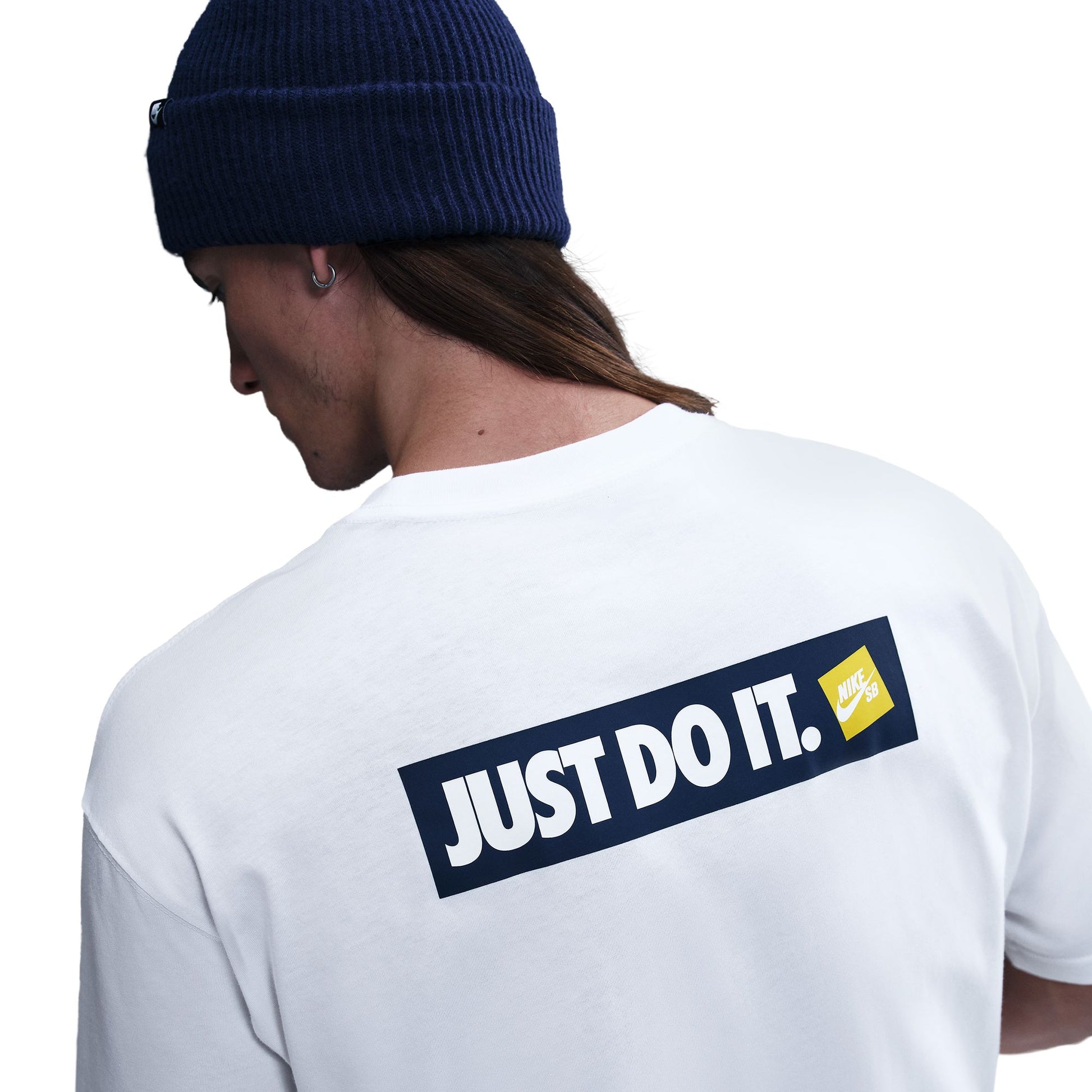 Person wearing a white t-shirt with 'Just Do It' logo on the back, facing away from the camera.