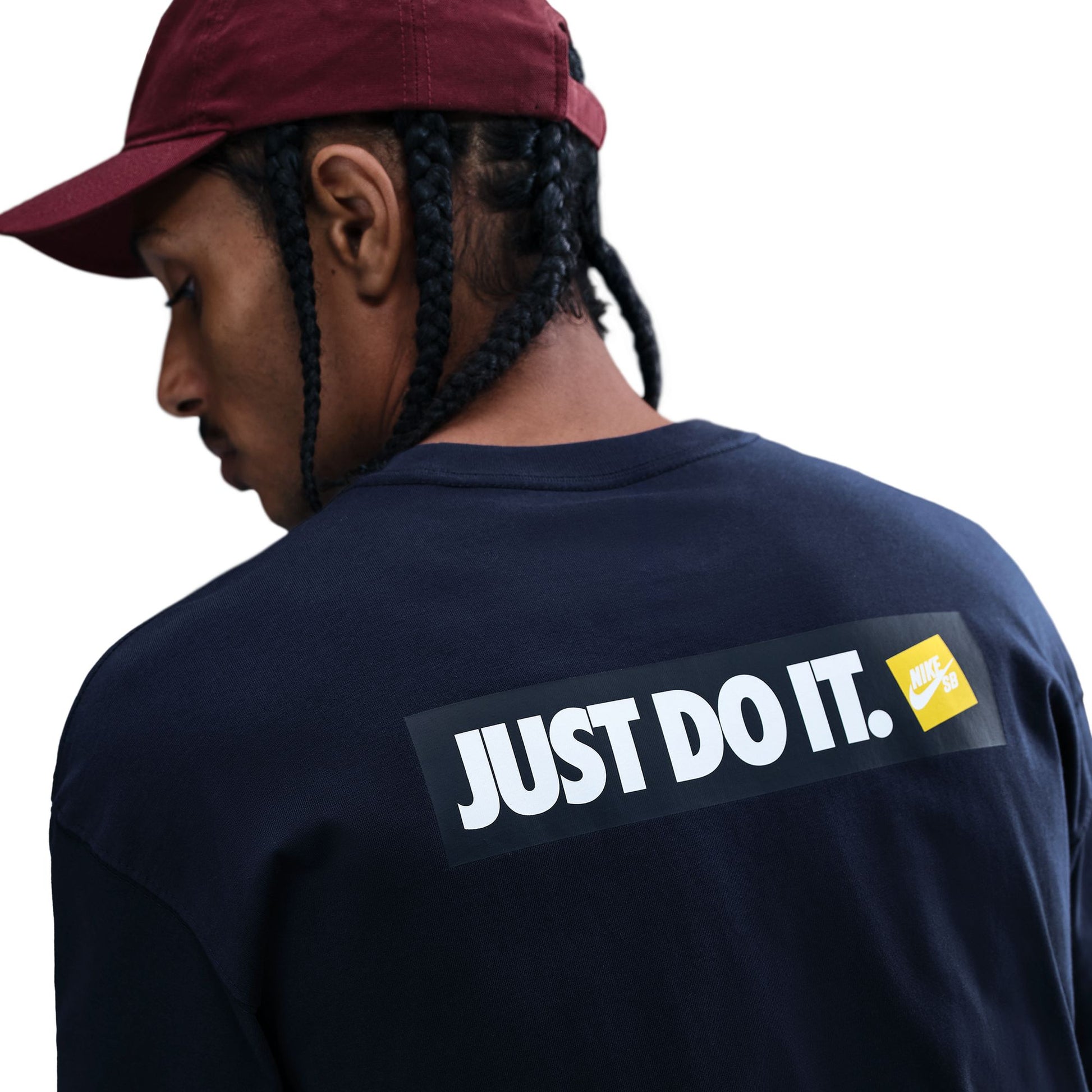 Person wearing a navy blue shirt with 'Just Do It' logo, facing away from the camera.