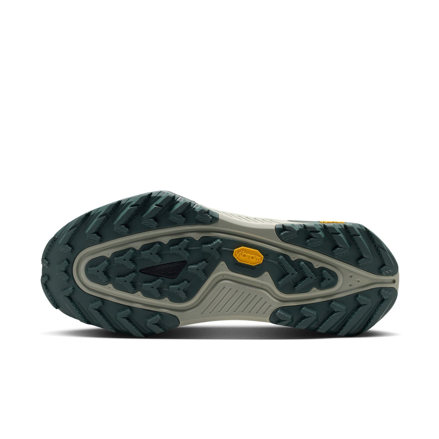 A close-up bottom view of a trail shoe's rugged outsole, featuring a dark green treaded design, a light gray midsole, and a small yellow Vibram logo on a white background.