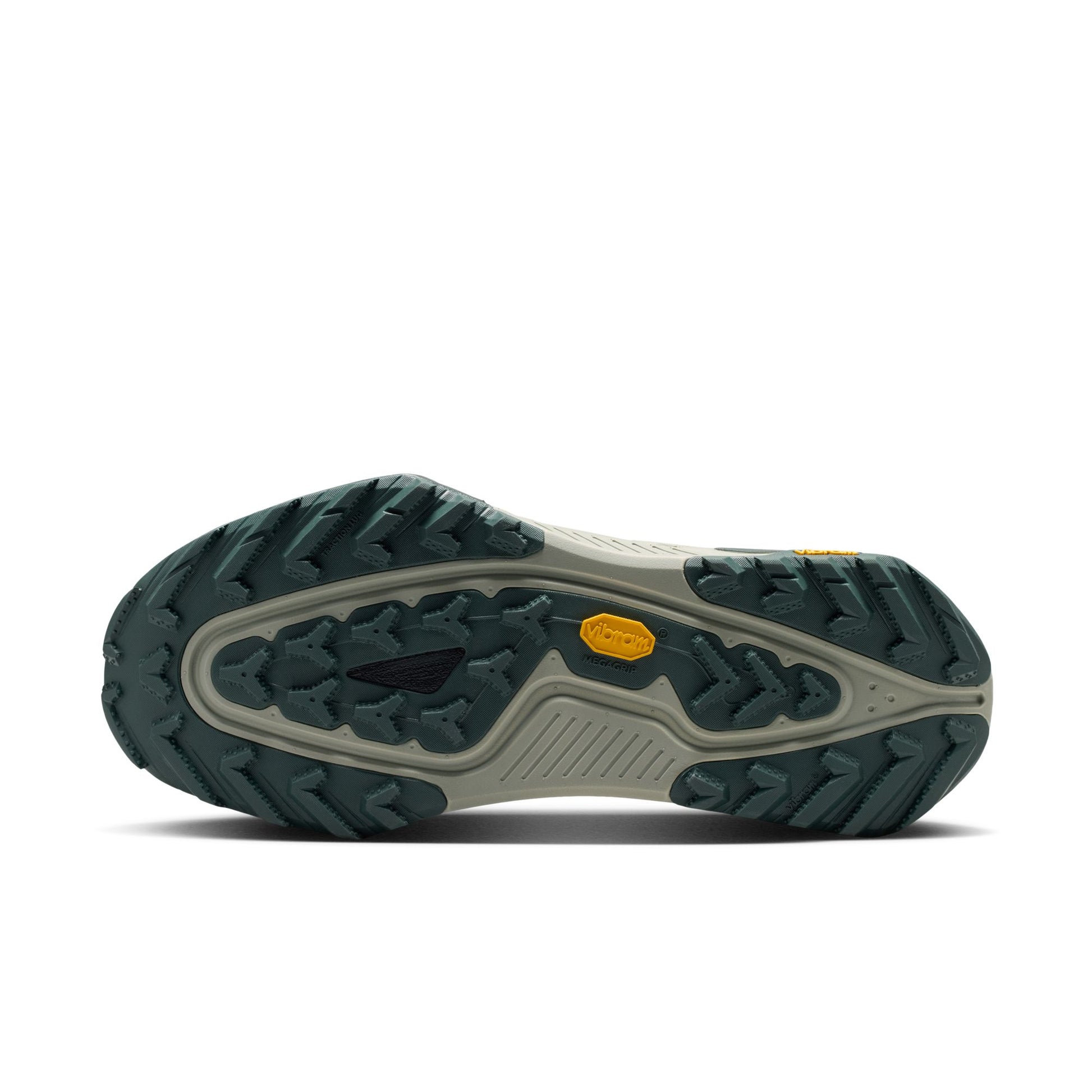 A close-up bottom view of a trail shoe's rugged outsole, featuring a dark green treaded design, a light gray midsole, and a small yellow Vibram logo on a white background.