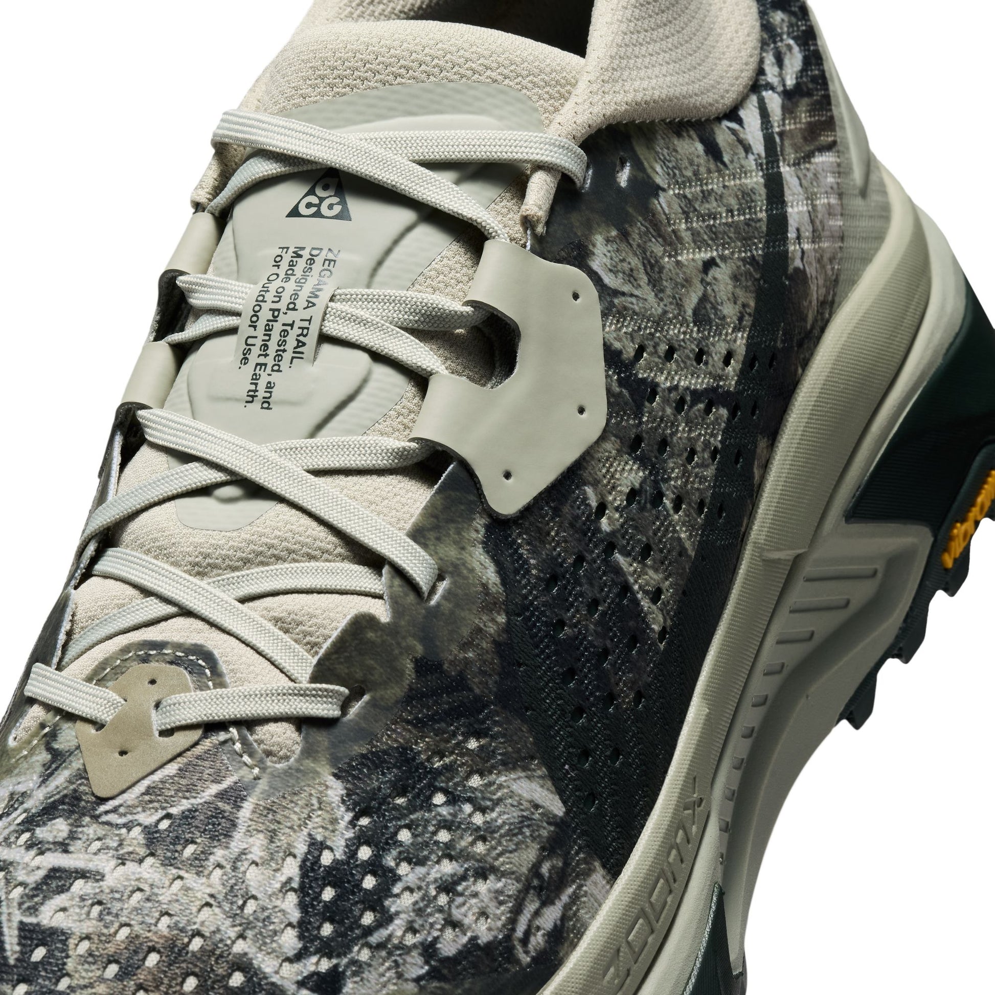 Camouflage trail running sneaker with brand logo on a white background