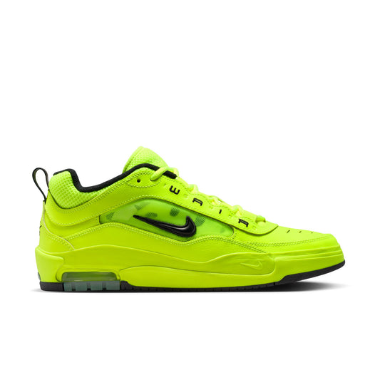 Bright green sneaker with black accents on a white background
