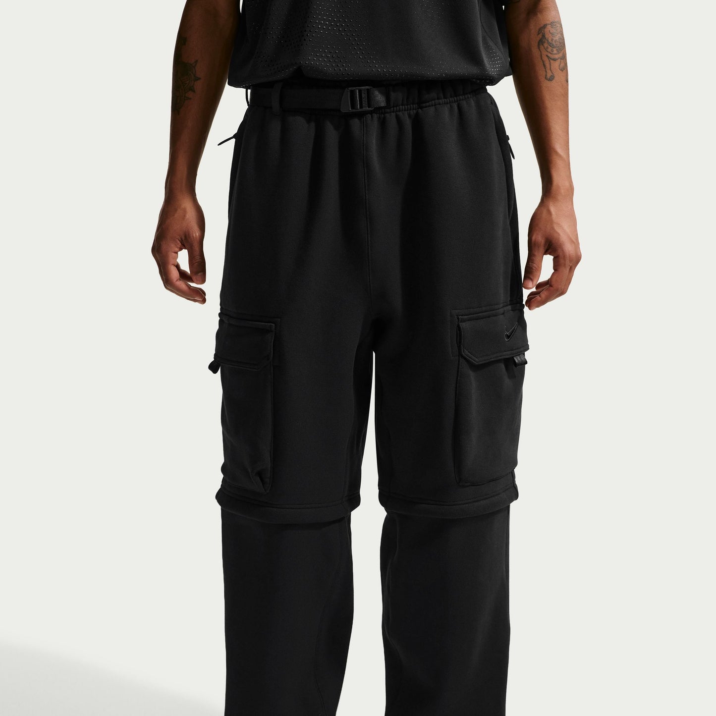 Black cargo pants worn by a person on a white background