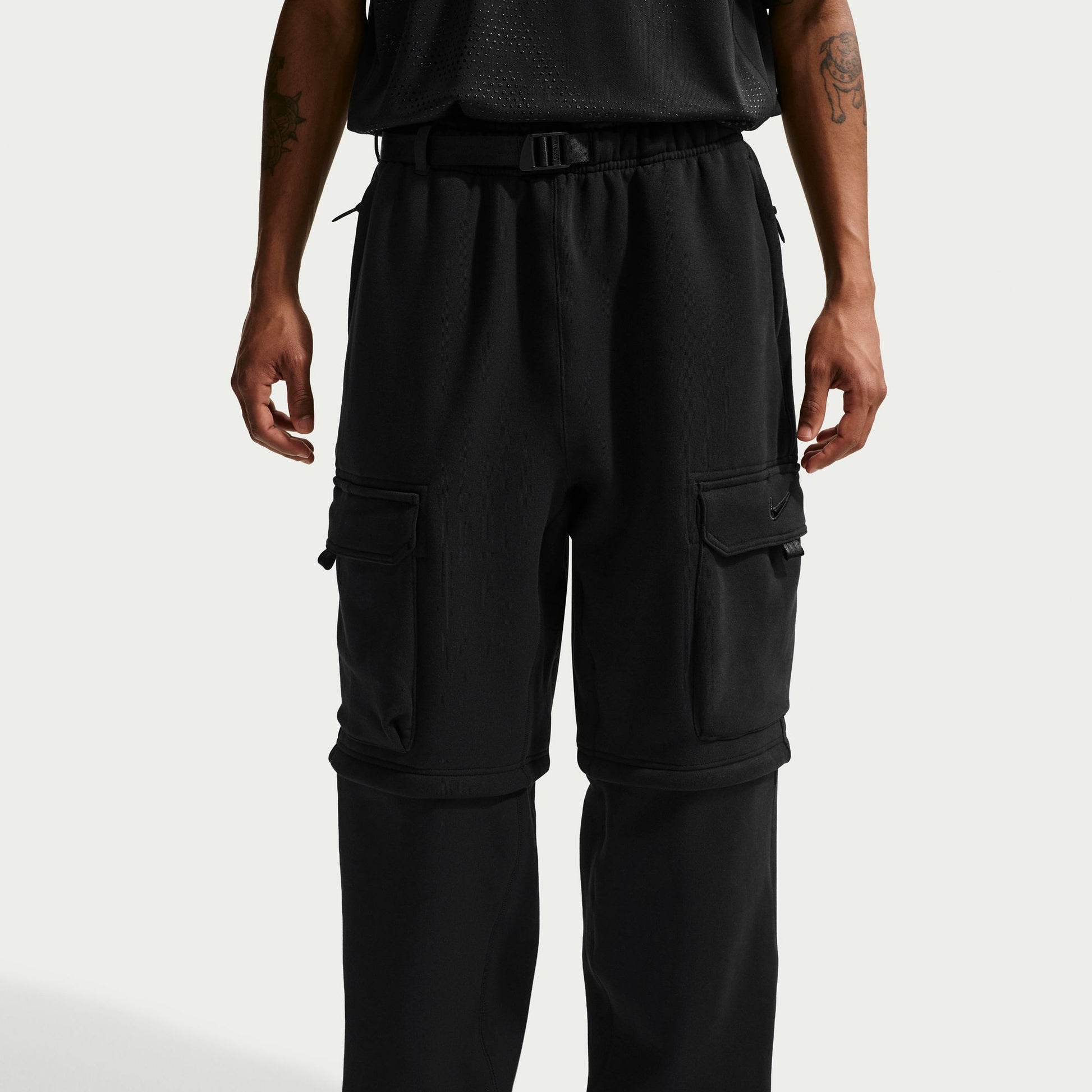 Black cargo pants worn by a person on a white background